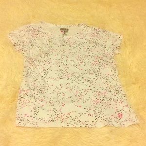 A small, white, patterned T-Shirt.